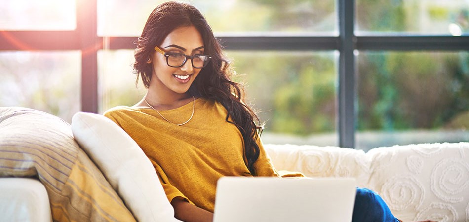 woman using a laptop from couch